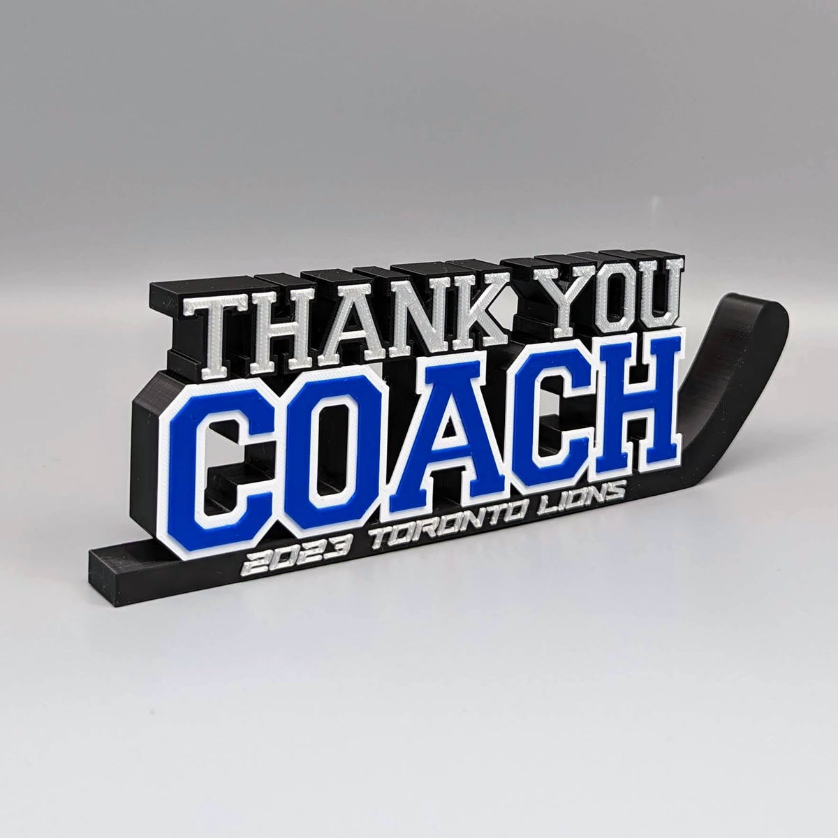 "Thank You Coach" hockey stick nameplate in blue and black, a coach gift