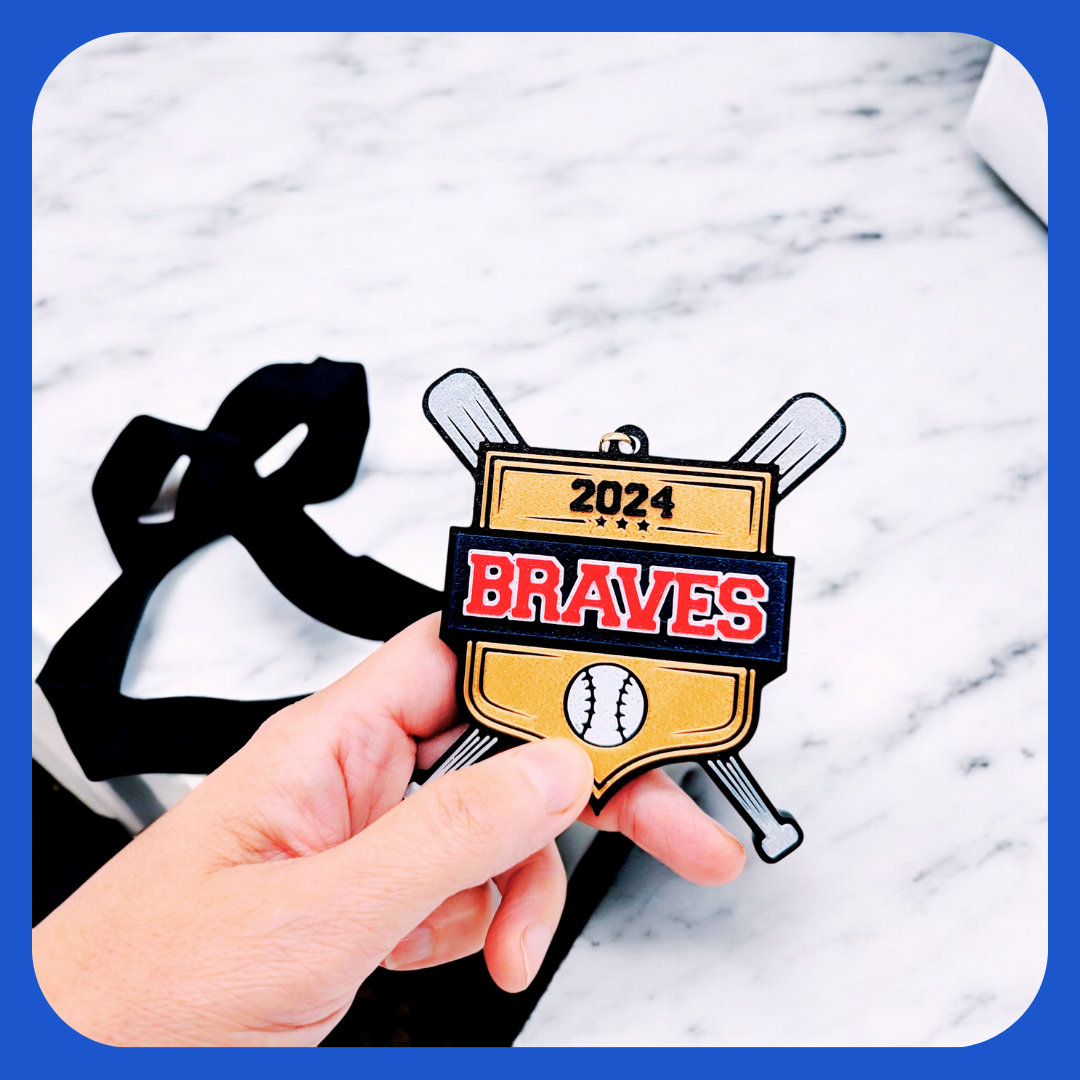 Baseball medal with gold shield, crossed bats, bold team name and year