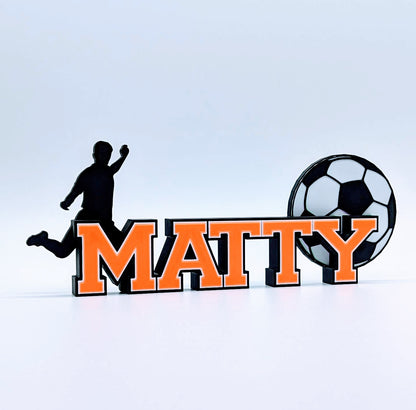 Custom soccer name sign "MATTY" in orange with kicking player and soccer ball