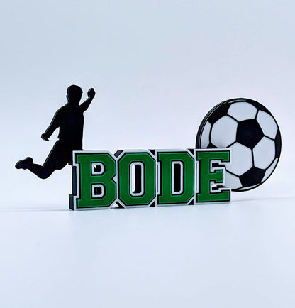 Custom soccer nameplate "BODE" in green, white and black for a young player