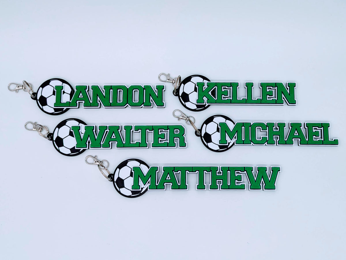 Five green soccer bag tags for a team: LANDON, KELLEN, WALTER, MICHAEL, MATTHEW
