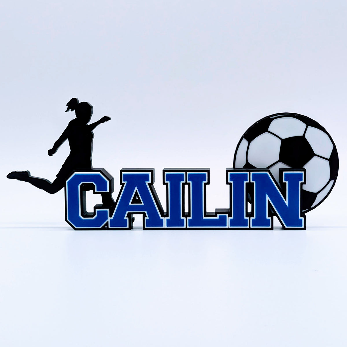 Girls soccer nameplate "CAILIN" in royal blue with female player silhouette