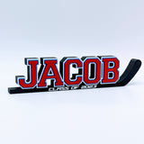 Hockey stick nameplate "JACOB" in red, white and blue with "Class of 2023"