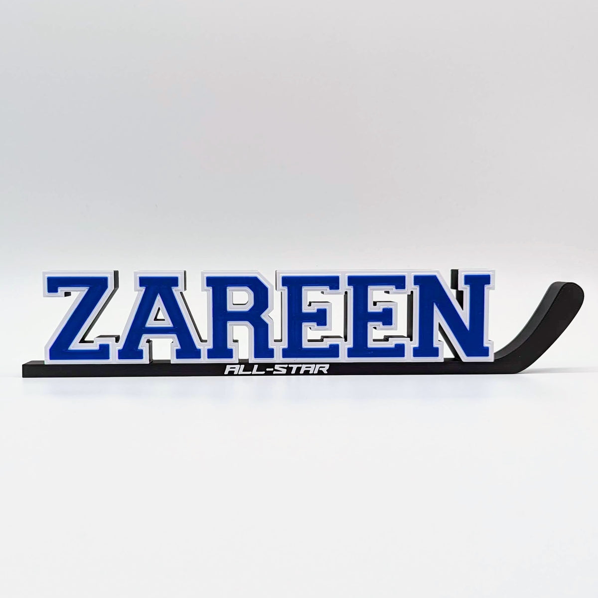 Hockey stick nameplate "ZAREEN" in blue and white with "All-Star"