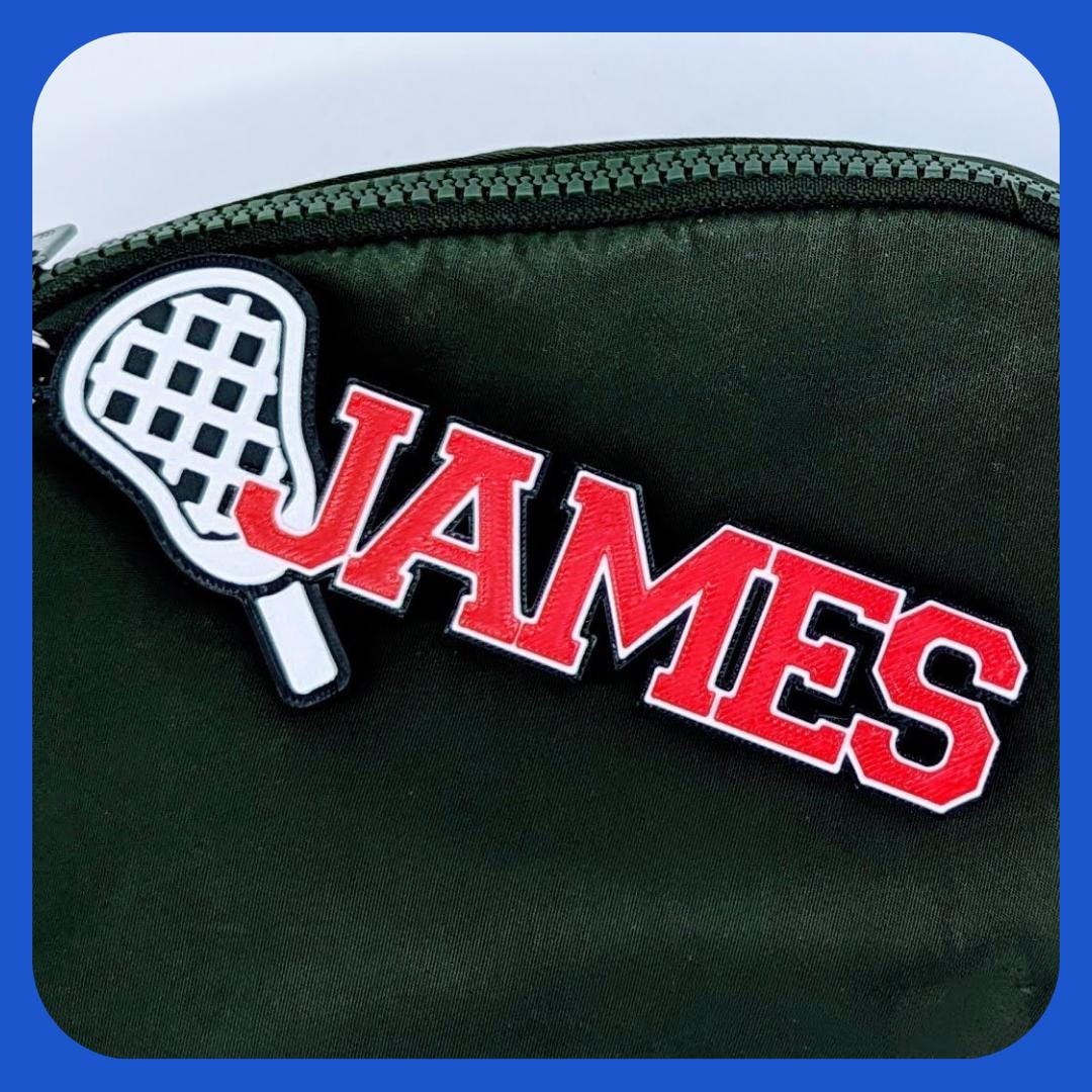 Lacrosse bag tag "JAMES" in red on a green sports bag