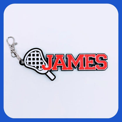 Lacrosse bag tag "JAMES" in red with white lacrosse stick head