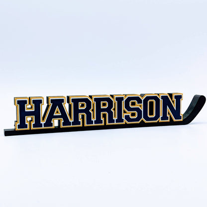 Personalized hockey stick nameplate "HARRISON" in navy and gold