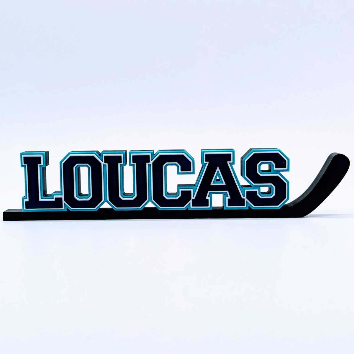 Personalized hockey stick nameplate "LOUCAS" in black and teal