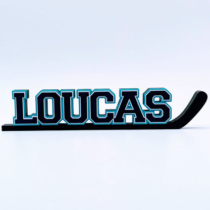 Personalized hockey stick nameplate "LOUCAS" in black and teal