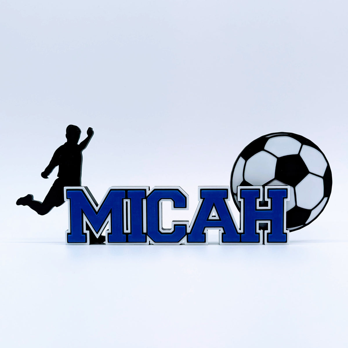 Personalized soccer nameplate "MICAH" in royal blue with player and ball