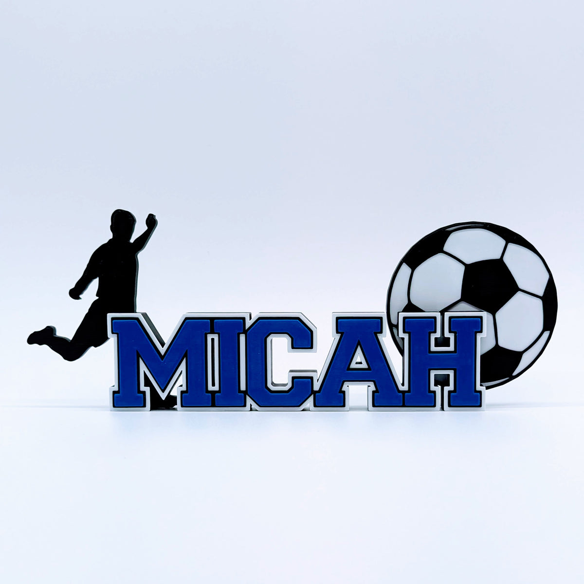 Personalized soccer nameplate "MICAH" in royal blue with player and ball