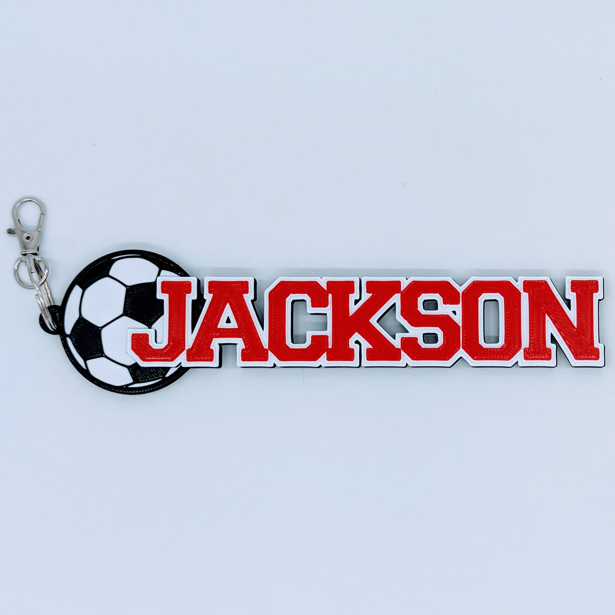 Soccer bag tag "JACKSON" in red and white with soccer ball