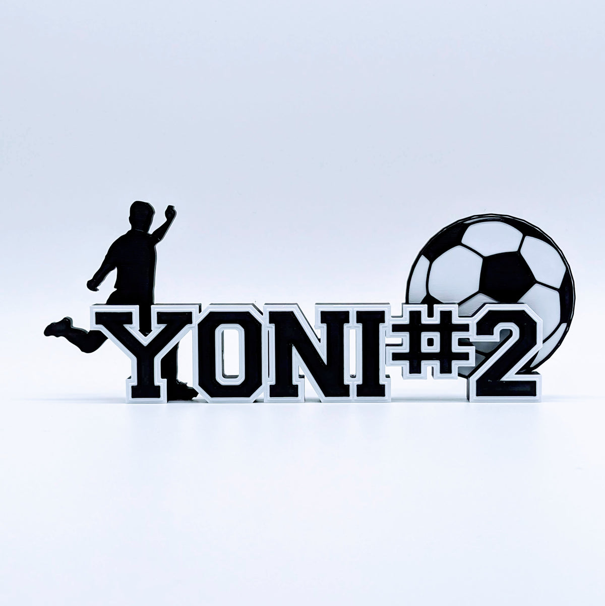 Soccer nameplate "YONI #2" in black and white with jersey number