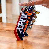 Hockey stick bag tags in team colors hanging from a hand