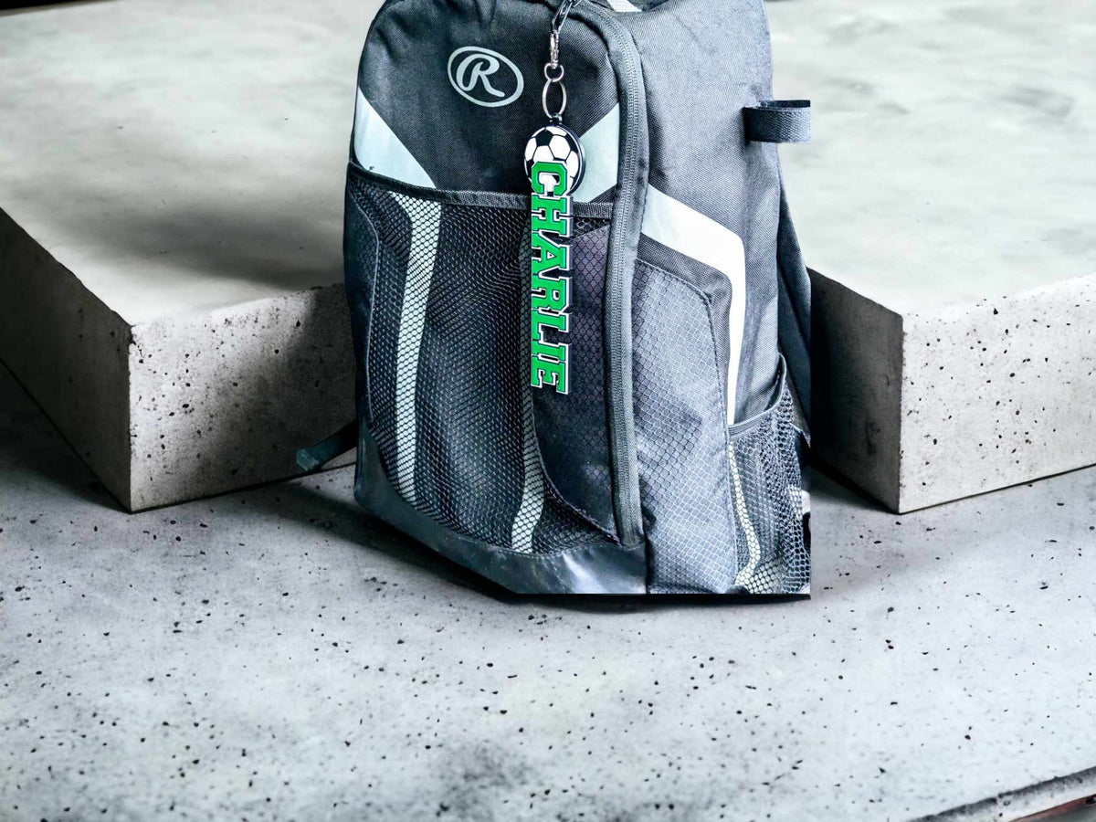 Soccer bag tag "CHARLIE" on a sports backpack outdoors