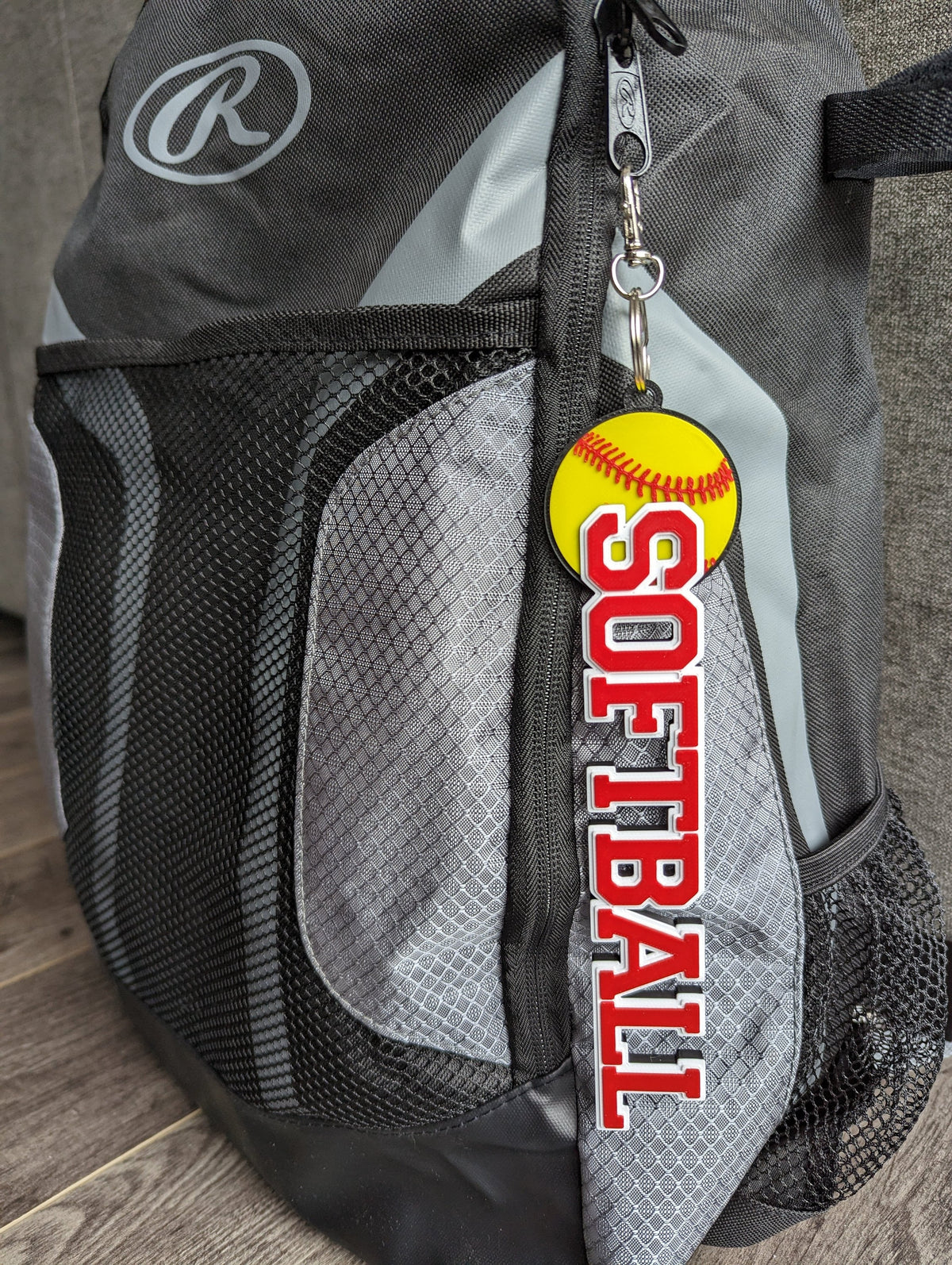 Softball bag tag in red and white with yellow softball on a backpack